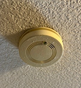 Outdated yellowed smoke detector in Mansfield Texas home