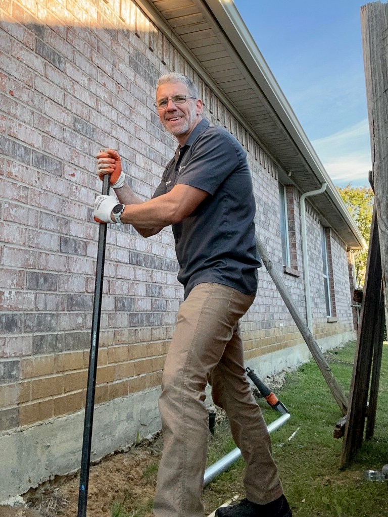 Steven repairing a wood fence post in Mansfield TX